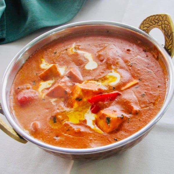 Madurai Kitchen and Bar's paneer butter masala, a rich Indian curry with paneer, cream, and red chili.